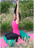 Woman practicing yoga with a lymphedema sleeve